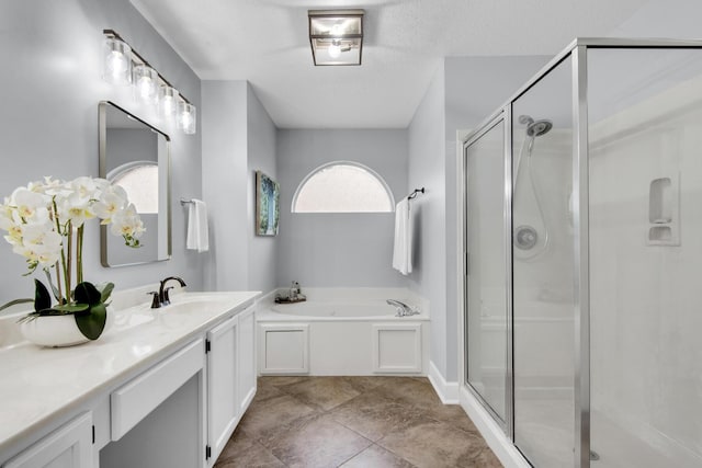 full bath featuring a garden tub, a textured ceiling, a shower stall, and vanity