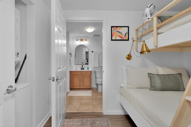 bathroom featuring visible vents, toilet, vanity, wood finished floors, and baseboards