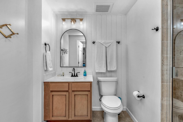 bathroom featuring baseboards, visible vents, tiled shower, toilet, and vanity