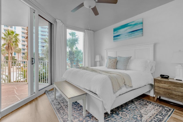 bedroom with light wood-style floors, a ceiling fan, and access to exterior