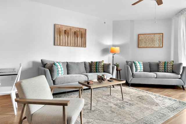 living room with ceiling fan and wood finished floors