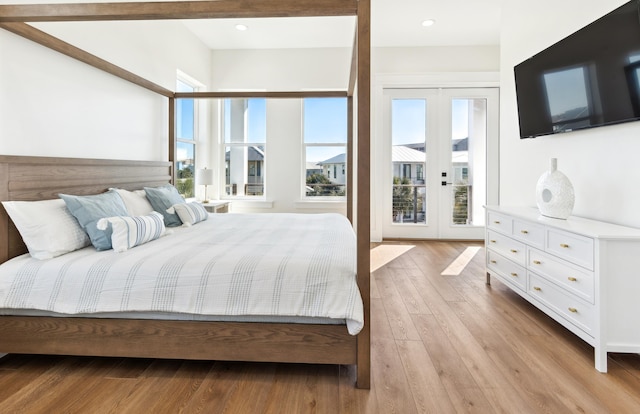 bedroom featuring light wood-style floors, access to exterior, and french doors