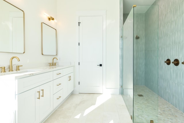 bathroom featuring double vanity, tile patterned flooring, walk in shower, and a sink