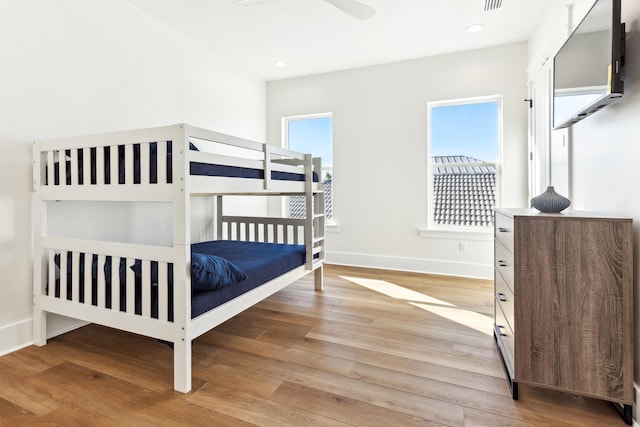 bedroom with light wood-type flooring, visible vents, baseboards, and recessed lighting