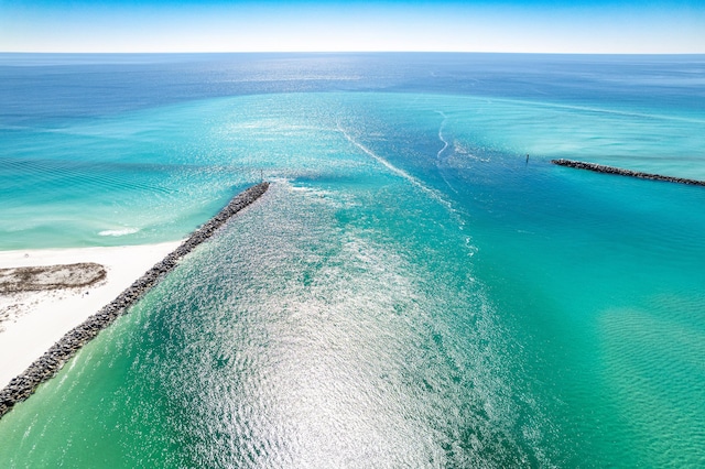 bird's eye view with a water view and a beach view