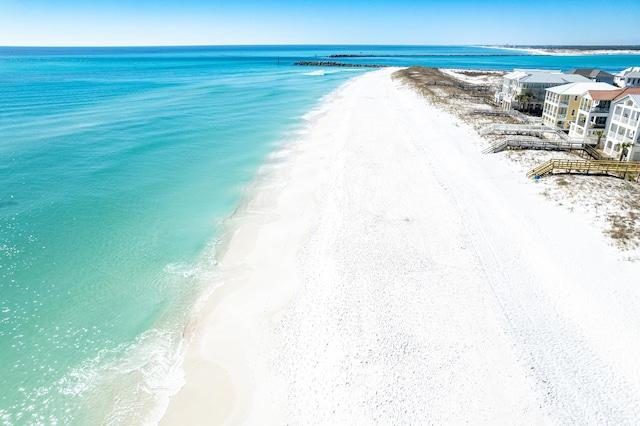 birds eye view of property featuring a water view and a view of the beach