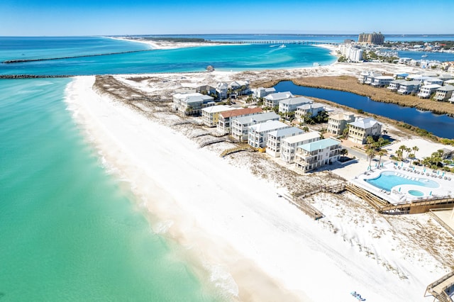 drone / aerial view featuring a beach view and a water view