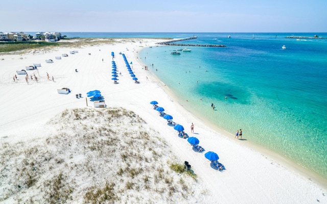 bird's eye view featuring a water view and a view of the beach