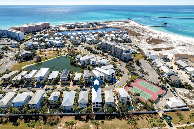 drone / aerial view with a water view and a beach view