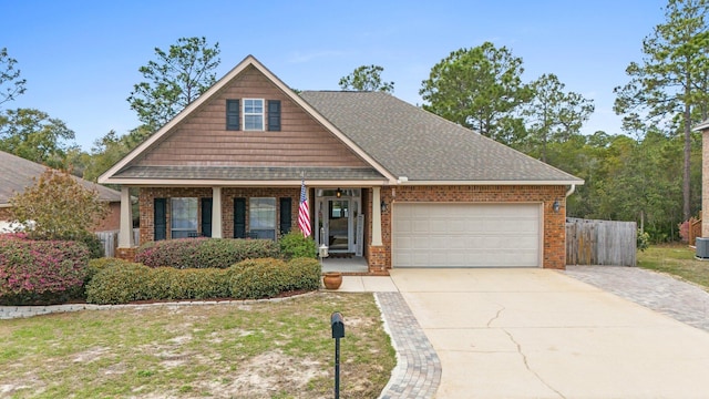 view of front of property with brick siding, a shingled roof, concrete driveway, an attached garage, and fence