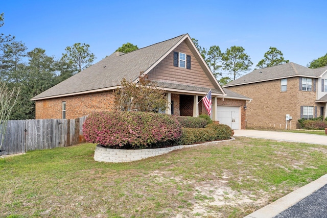 view of front of property featuring brick siding, an attached garage, a front yard, fence, and driveway