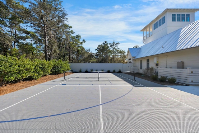 view of sport court featuring a tennis court, fence, and basketball court