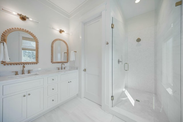 full bath with ornamental molding, a stall shower, a sink, and double vanity