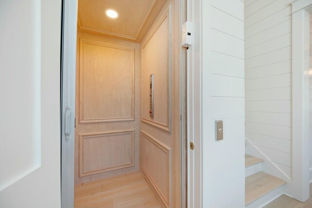 room details with elevator, wood finished floors, and recessed lighting