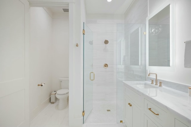 full bath with vanity, a shower stall, toilet, and baseboards