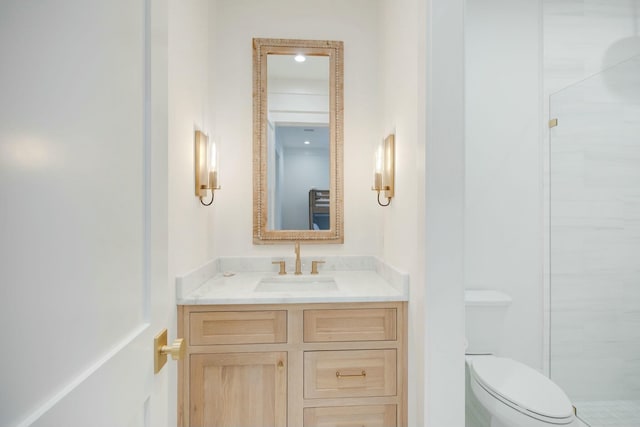 bathroom featuring vanity, toilet, and an enclosed shower