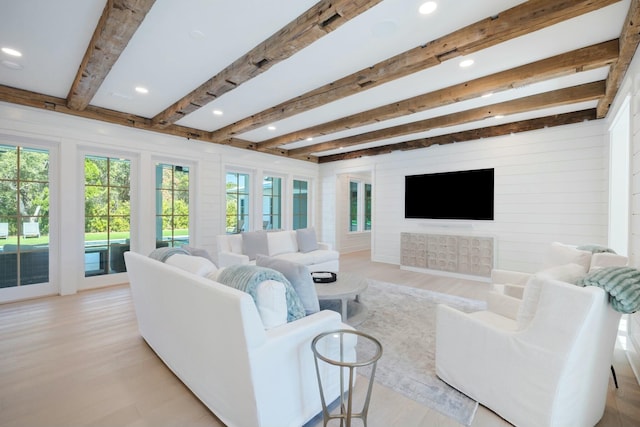 living area featuring light wood finished floors, beamed ceiling, and recessed lighting