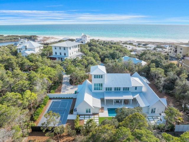 bird's eye view featuring a water view and a beach view