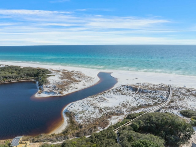 bird's eye view featuring a water view and a beach view