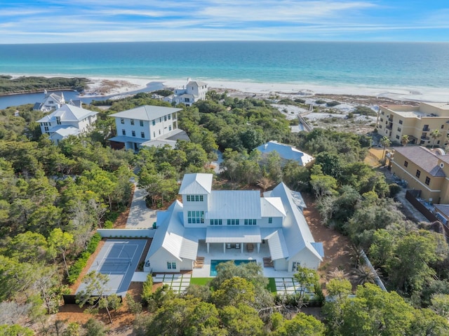 drone / aerial view featuring a water view and a view of the beach