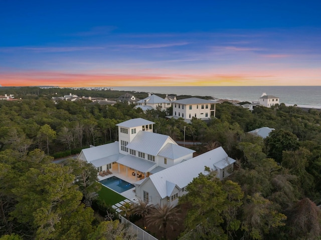 aerial view at dusk with a water view