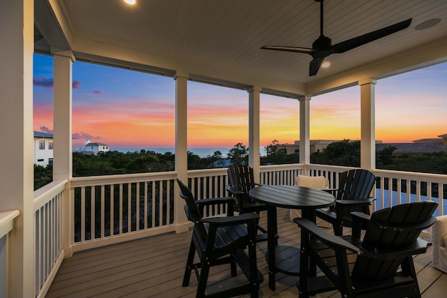 sunroom featuring ceiling fan, wood ceiling, and a wealth of natural light