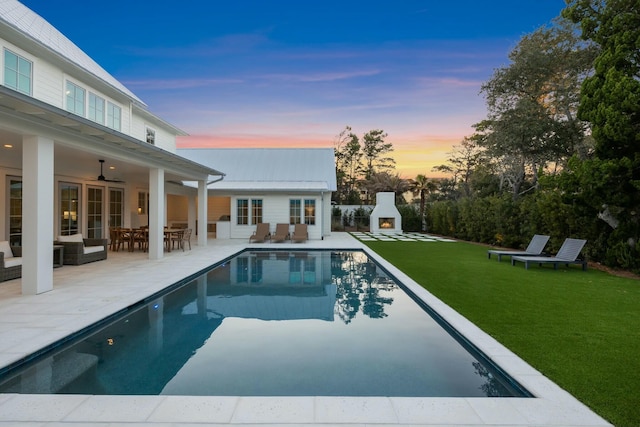 outdoor pool featuring a patio area, outdoor dining area, a ceiling fan, and a yard