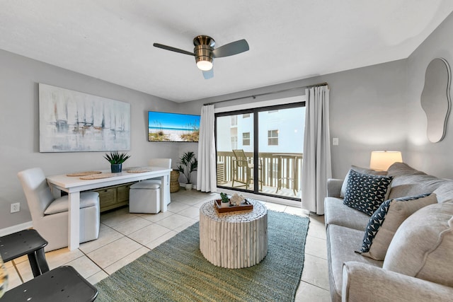 living area with light tile patterned floors and ceiling fan