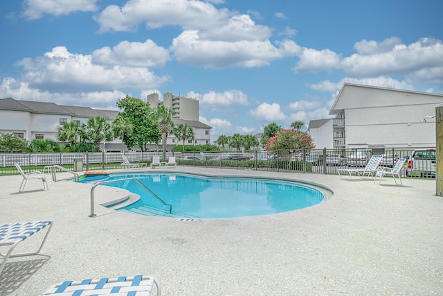 pool featuring a patio area and fence