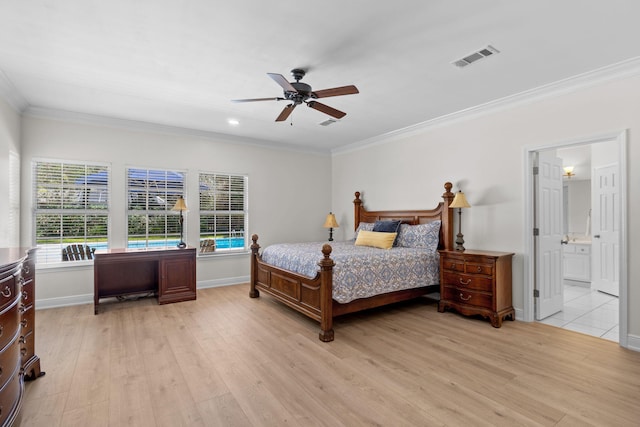 bedroom featuring baseboards, light wood-style flooring, visible vents, and crown molding