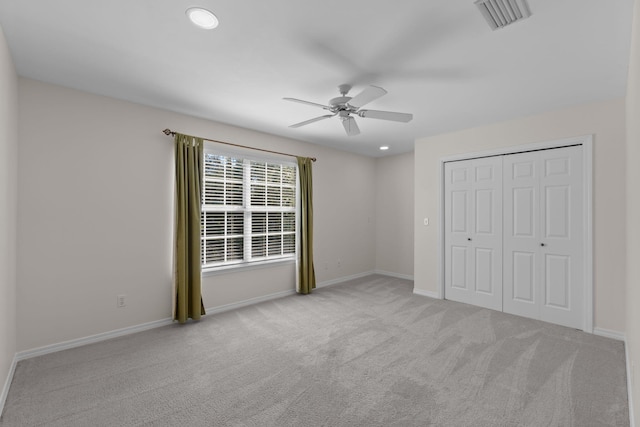 unfurnished bedroom with a closet, carpet flooring, visible vents, and baseboards