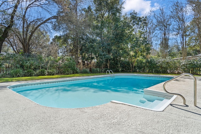 outdoor pool with a patio area