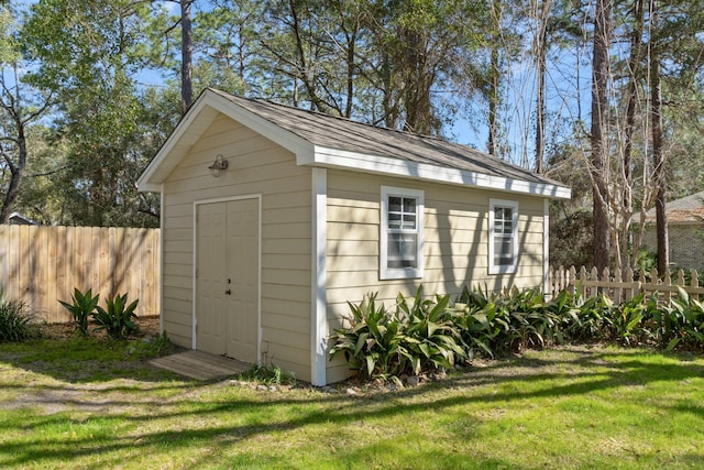 view of outbuilding with fence and an outdoor structure