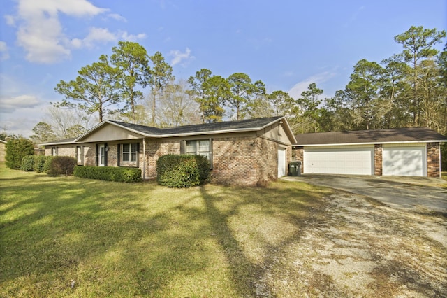 ranch-style home featuring a front yard, concrete driveway, brick siding, and an attached garage