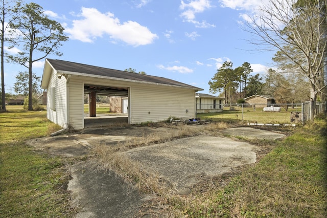 back of property with a lawn and fence