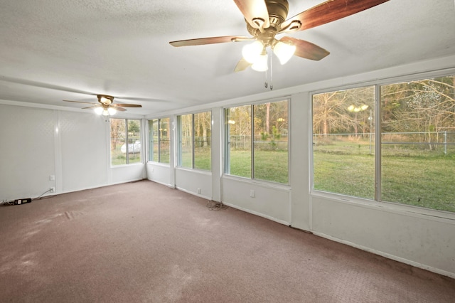 unfurnished sunroom with ceiling fan