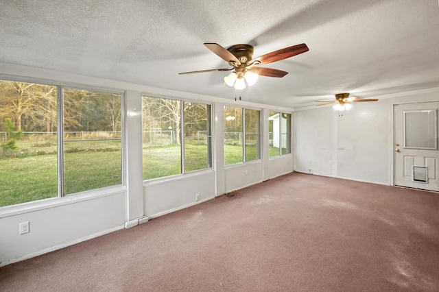 unfurnished sunroom with ceiling fan