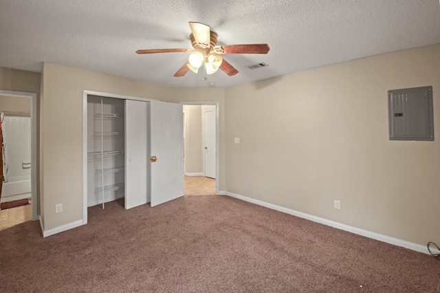 unfurnished bedroom featuring carpet floors, electric panel, visible vents, and a closet