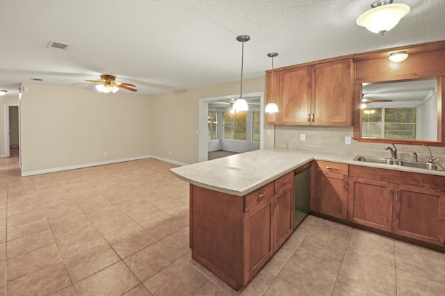 kitchen with a sink, plenty of natural light, light countertops, and dishwasher