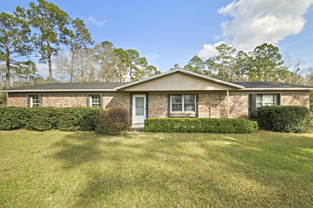 ranch-style house featuring brick siding and a front lawn