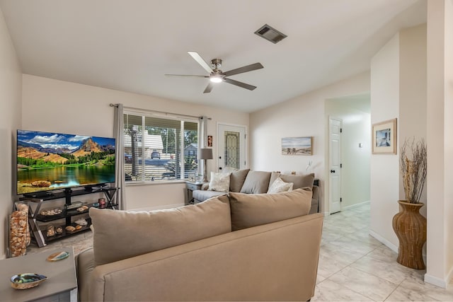 living room featuring a ceiling fan, visible vents, vaulted ceiling, and baseboards