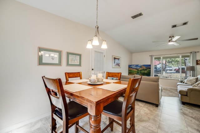 dining space featuring baseboards, visible vents, vaulted ceiling, and a ceiling fan