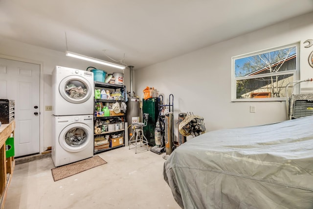 bedroom featuring stacked washing maching and dryer and concrete flooring