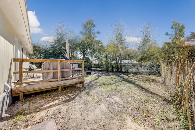 view of yard featuring a fenced backyard and a wooden deck