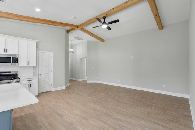 kitchen with baseboards, decorative backsplash, visible vents, stainless steel appliances, and light countertops