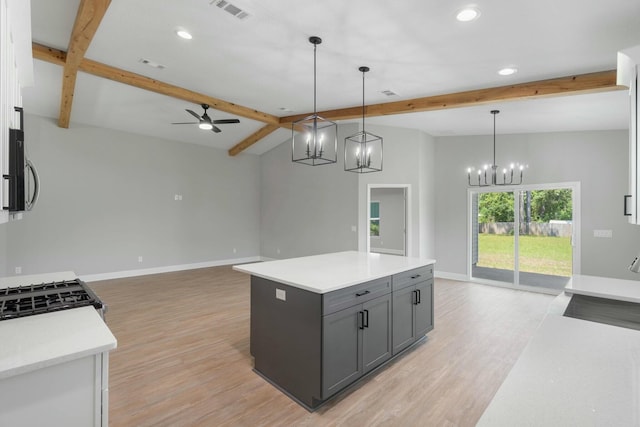 kitchen with baseboards, beam ceiling, visible vents, and gray cabinetry