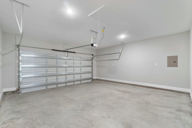 garage featuring baseboards, electric panel, and a garage door opener