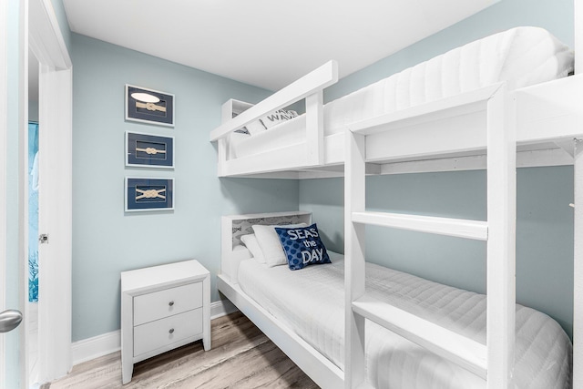 bedroom featuring baseboards and wood finished floors