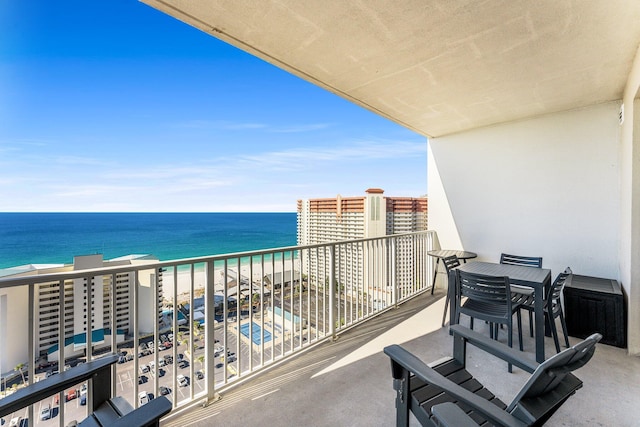 balcony featuring a water view and a view of the beach