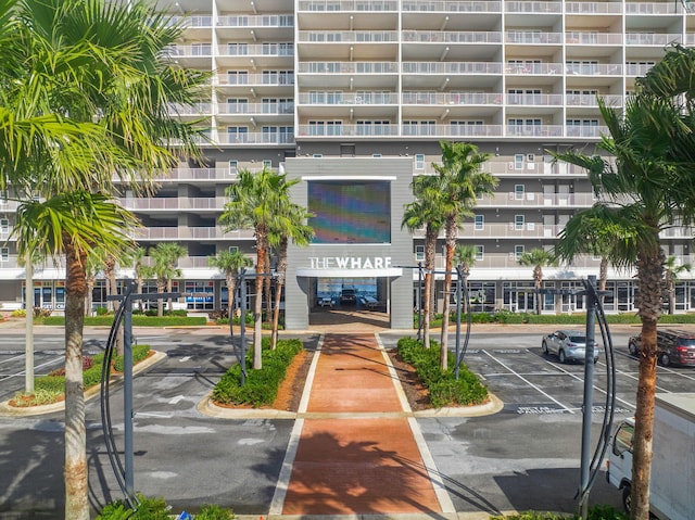 view of building exterior with uncovered parking